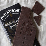 Dark chocolate bar with Meurisse branding on a textured surface