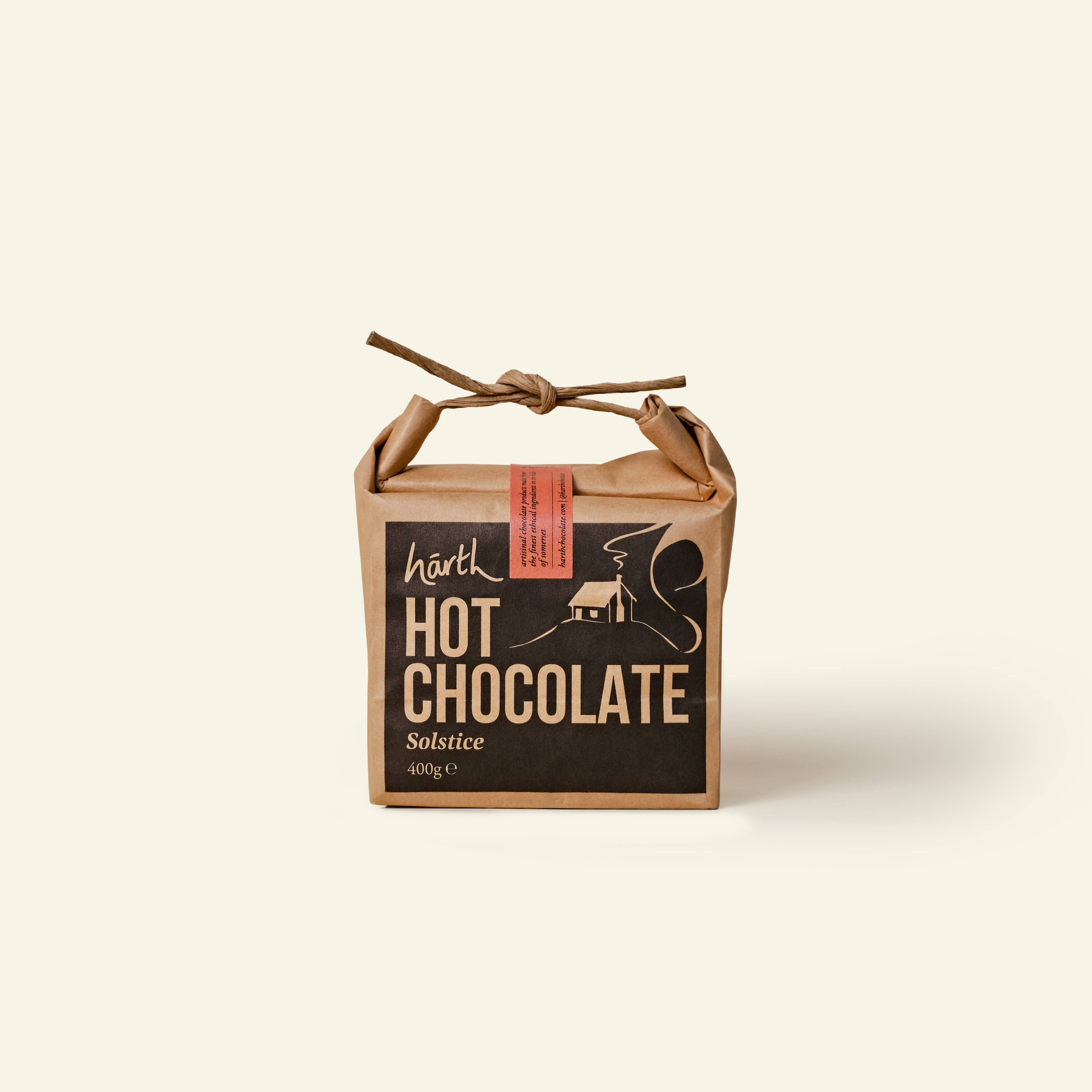Box of hot chocolate with a rustic design on a beige background