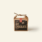 Box of hot chocolate with a rustic design on a beige background