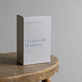 Box of 'Chamomile Blossoms' from Nectar & Leaf on a wooden table with a gray background