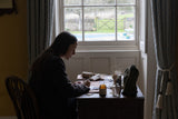 georgie, founder of bundle & beau sat writing a gift note