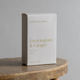 White box labeled 'Lemongrass & Ginger' on a wooden surface with a gray background