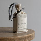 Product packaging labeled 'Vely Sea Meditation' on a wooden surface with a neutral background